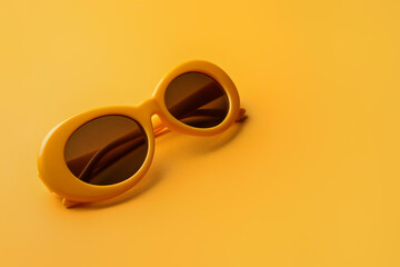 Stylish sunglasses on color background