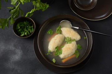 Griessnockerlsuppe. Clear Soup with Semolina Dumplings in a bowl. German food. Bavarian cuisine.