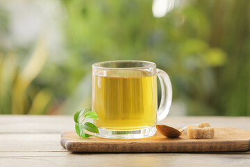 Cup of green tea on table outdoors