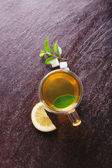 Cup of green tea on dark background
