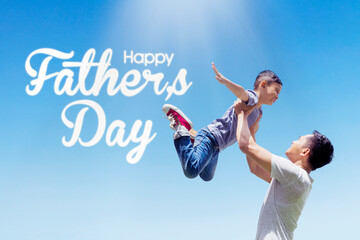 Fototapeta na wymiar Man lifts his son near the Happy Fathers Day text