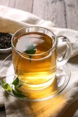 Cup of green tea on wooden background