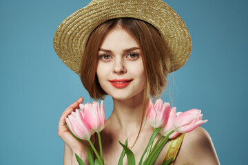 Elegant woman in a hat with a gift bouquet of flowers celebrate close-up