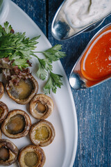 baked mushrooms mushrooms with sauce on a white plate