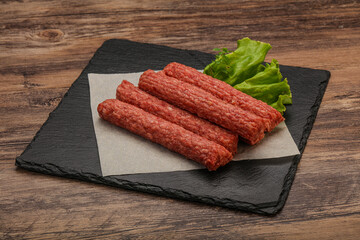 Raw beef sausages with spices