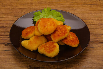 Fried chicken nuggets served salad leaves
