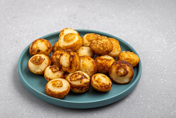 Suji appe or appam served on a appam pan with peanuts and tamarind chutney
