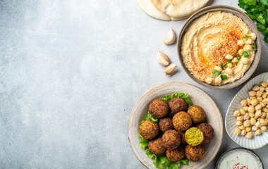 Chickpea dishes, falafel and hummus, on a concrete background, top view, copy space