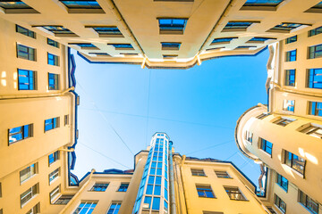 Profitable house  of yellow well with patio courtyard against blue sky in the historic center in St. Petersburg.