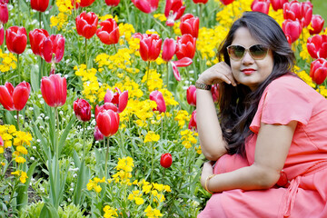 Indian Girl in pink dress in a  pink Tulip Garden