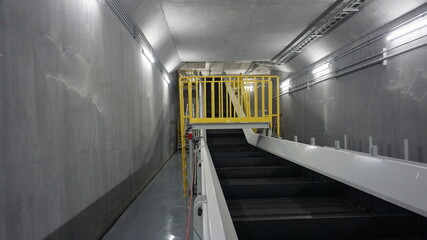 Access ladder and platform with guardrail of the underground metal waste material conveyor in the...