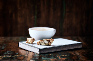 Cantuccini (Italian cookie) and Cappuccino on dark wooden background. Close up. 