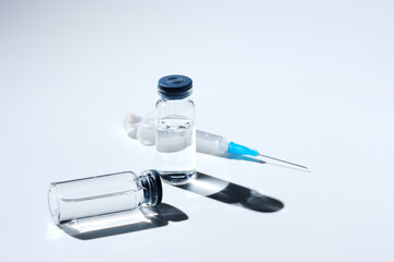 Close up glass vial with flu vaccine and syringe with needle. The concept of vaccination or...