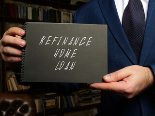 Financial concept about REFINANCE HOME LOAN with sign on blank notepad.