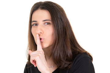young woman girl finger on lips in shh secret silence hand face gesture
