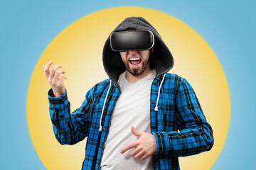 A man happily plays an imaginary guitar with the help of VR glasses. Yellow-blue background in the background. Virtual Reality Concept