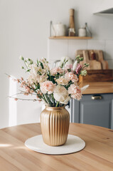 Spring bouquet on the table in the style interior in living room. Scandinavian style. White wooden...