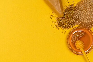 A ladle of honey on the background of a honeycomb of a bee. Honey tidbit in a glass jar honey...
