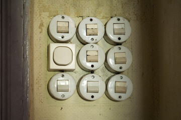 Closeup of nine old light switches in a derelict house