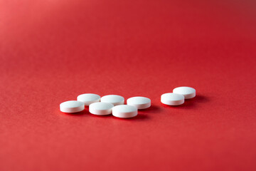 selective focus pills. white pills on the red ground