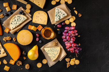 Cheese and wine. Lots of cheeses with grapes and a wineglass