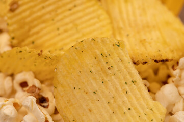Popcorn scattered on the table and potato chips. Self-isolation in the covid-19 pandemic.