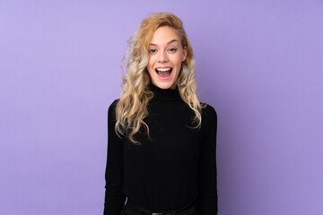 Young blonde woman isolated on purple background with surprise facial expression