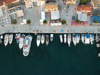 Fototapeta na wymiar aerial view luxury yachts and speedboats docked in yacht marina of sivota town tourist destination in greece