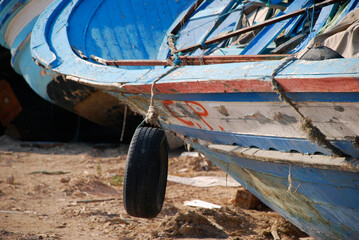 Tyre over boat. Lampedusa, Italy. Summer 2009.