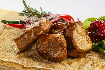 Pork tenderlion kebab over board