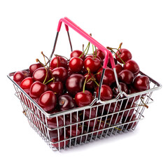 shopping basket full of sweet cherry fruits isolated on white background