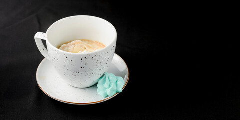Affogato coffee with ice cream in a white cup over black background.