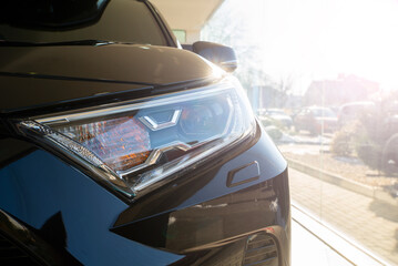 Obraz premium black new car headlight. Auto background. Spotlights.