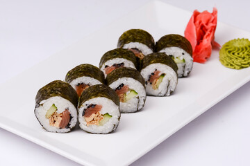 Japan sushi rolls isolated on white background served on a white plate.