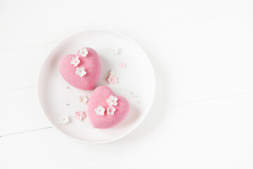 Heart  mousse cakes covered with pink  chocolate velour decorated of pink flowers