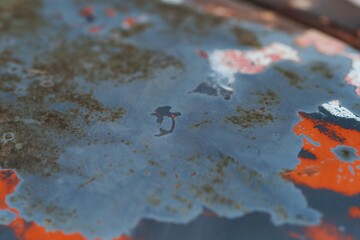 Closeup of Surface peeling old car paint cracked with rusty background