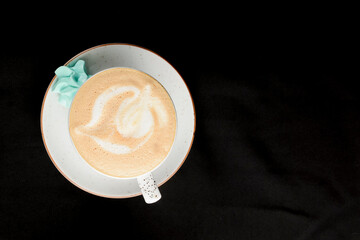 Cup of americano coffee with milk over black background. Coffeee time, isolated on black.