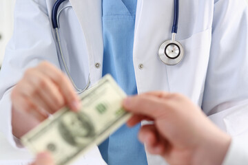 Female doctor hold hundred dollars banknote