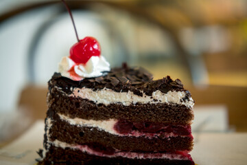 A delicious slice of black forrest cake on a plate and ready to eat
