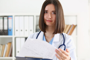 Beautiful smiling female doctor hold clipboard pad