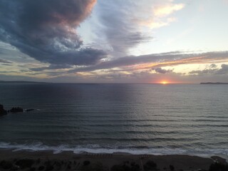 colorful sunset sky and horizon and clouds, in karavostasi beach of perdika in epirus, greece