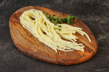 Chechil spaghetti cheese over board