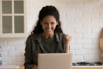 Close up excited woman looking at laptop screen, celebrating success, overjoyed young female...