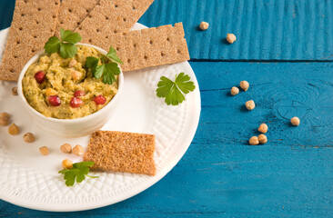 Top view of a plate of Turkish pea hummus appetizer. Copy space. Vegan food.