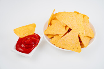 Nachos with tomato sauce on the white table. 