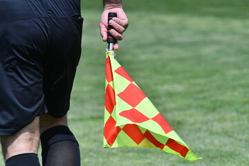 Assistant referee or Lineman of football or soccer holding flag