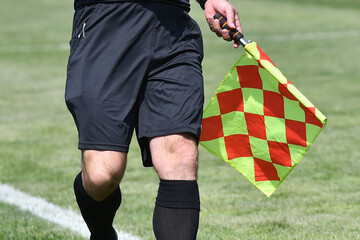 Assistant referee or Lineman of football or soccer holding flag