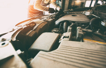 The mechanic fixing the car in the garage