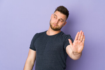 Fototapeta premium Russian handsome man over isolated background making stop gesture and disappointed