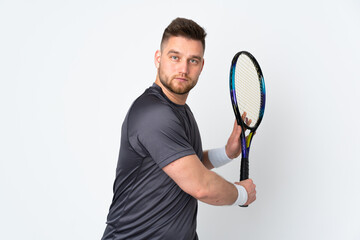 Russian handsome man isolated on white background playing tennis